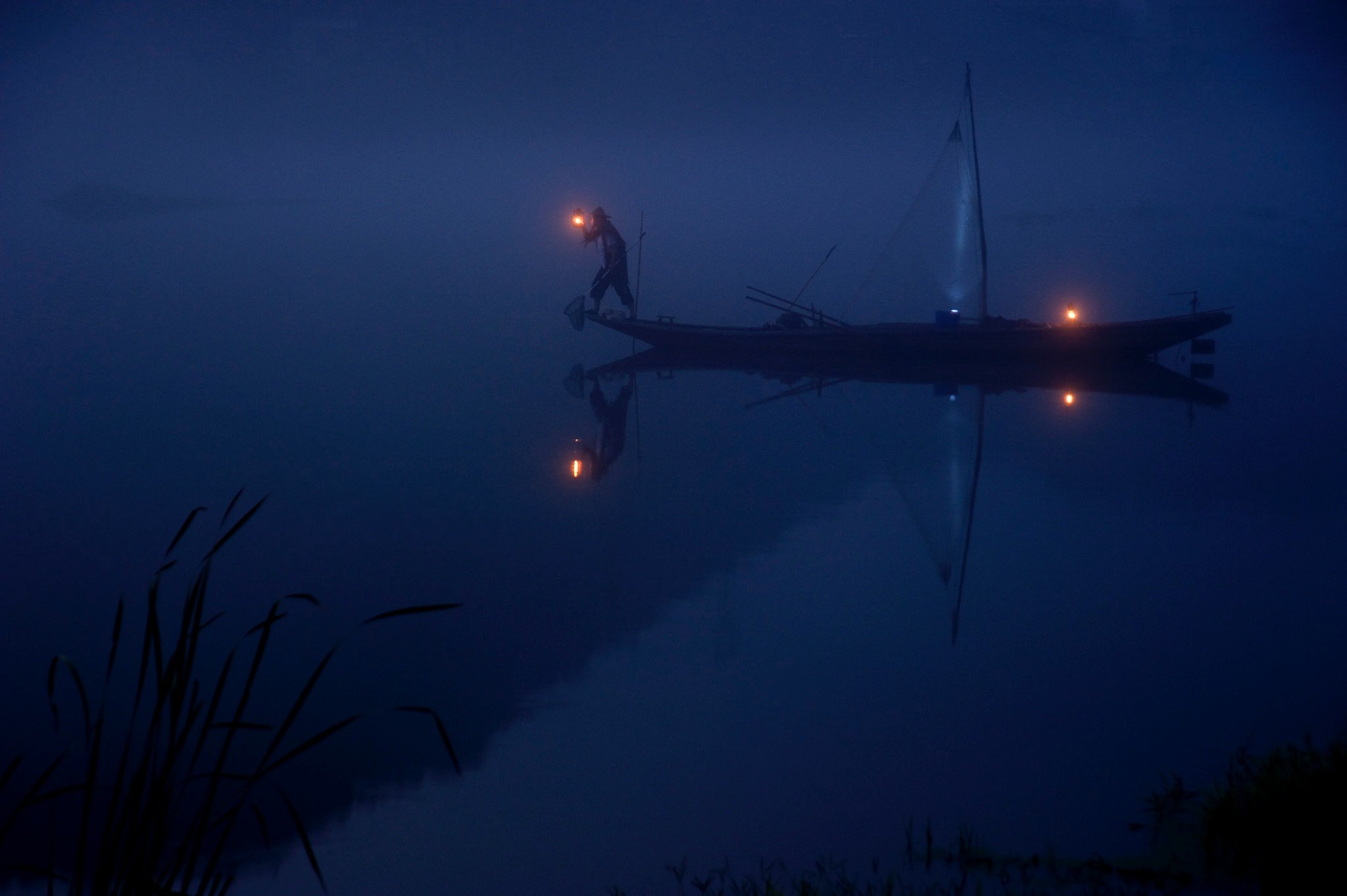 One man on the boat with a lamp